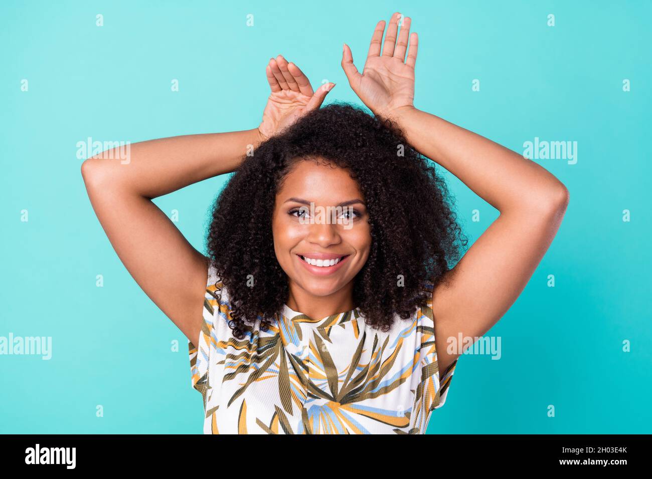 Photo of funny sweet dark skin woman dressed print blouse showing arms hair ears smiling isolated teal color background Stock Photo - Alamy Photo of funny sweet dark skin woman dressed print blouse showing arms hair ears smiling isolated teal color background Stock Photo - Alamy