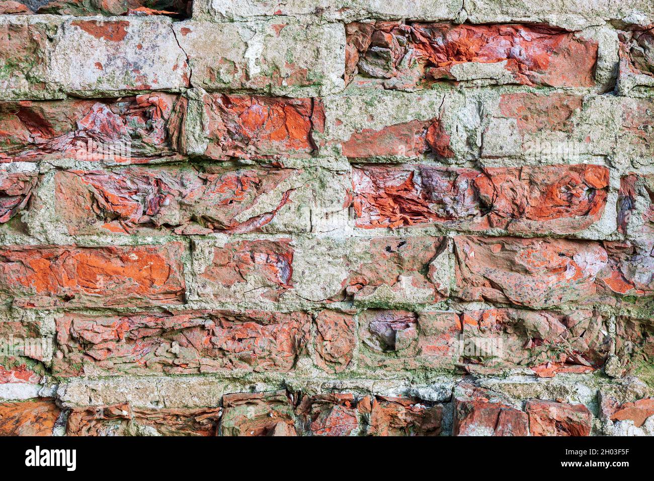Closeup of old red damaged brick wall Stock Photo