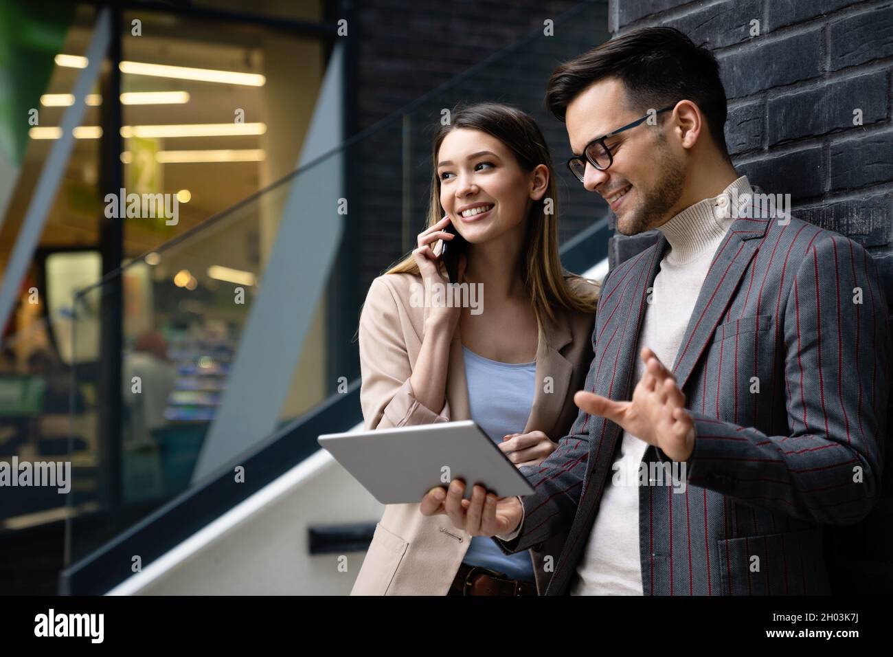 Portrait of successful business people working, talking together in urban background. Stock Photo