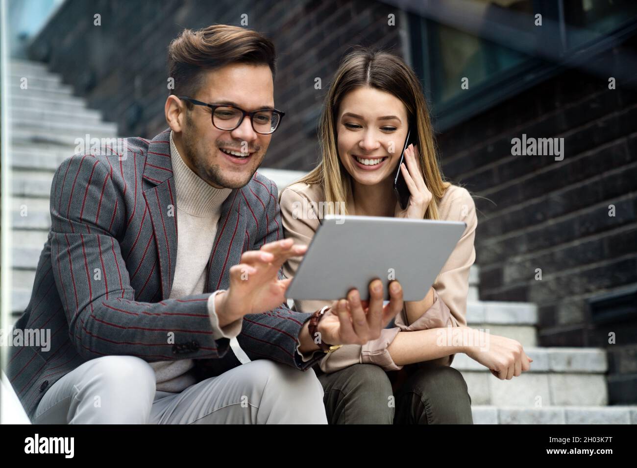 Portrait of successful business people working, talking together in urban background. Stock Photo