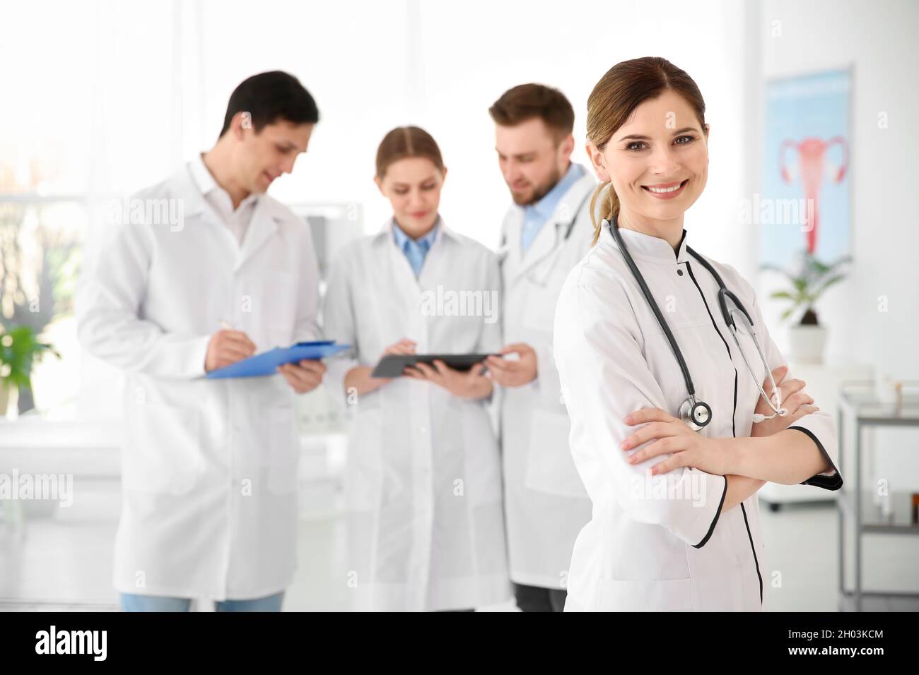 Smiling female doctor wearing uniform in modern hospital. Gynecology ...