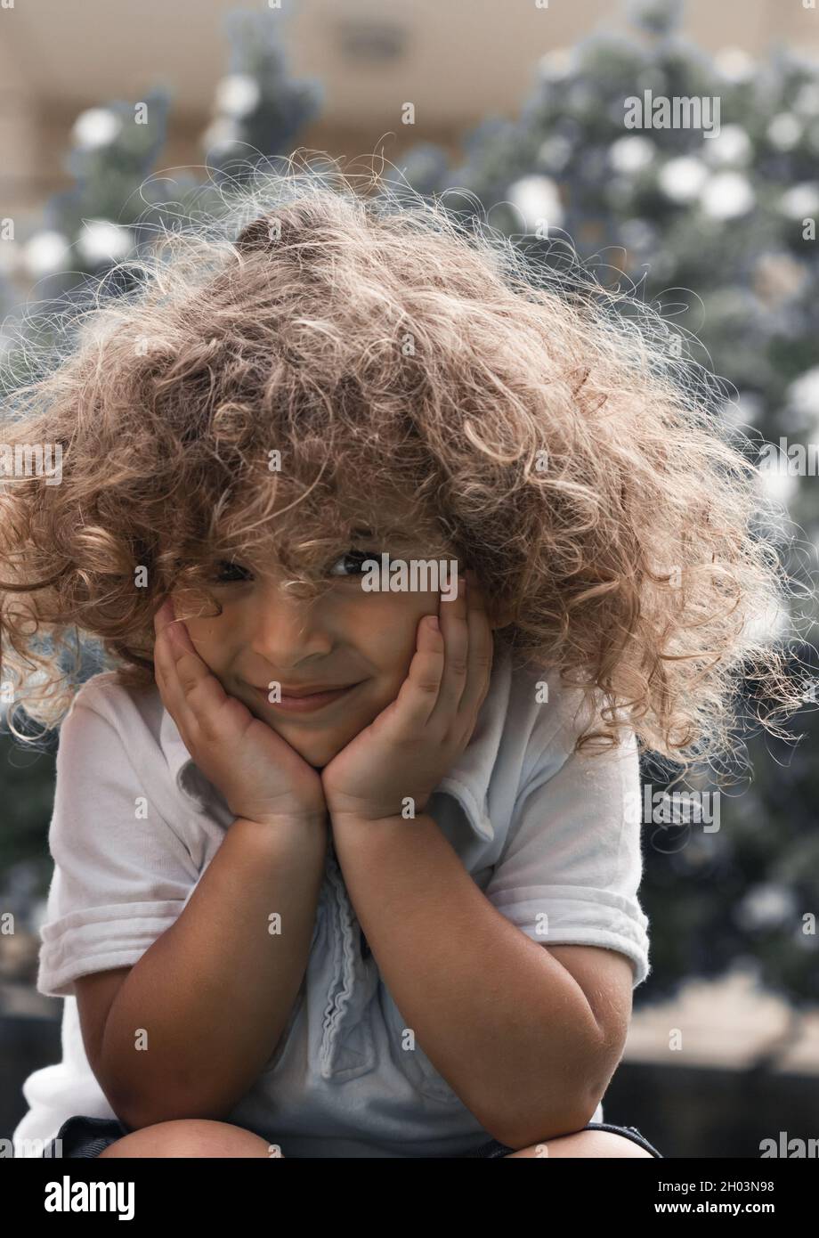 Closeup Portrait of a Nice Little Boy with a Beautiful Curly Hair. Happy Child Having Fun in the Park. Enjoying Carefree Childhood. Stock Photo