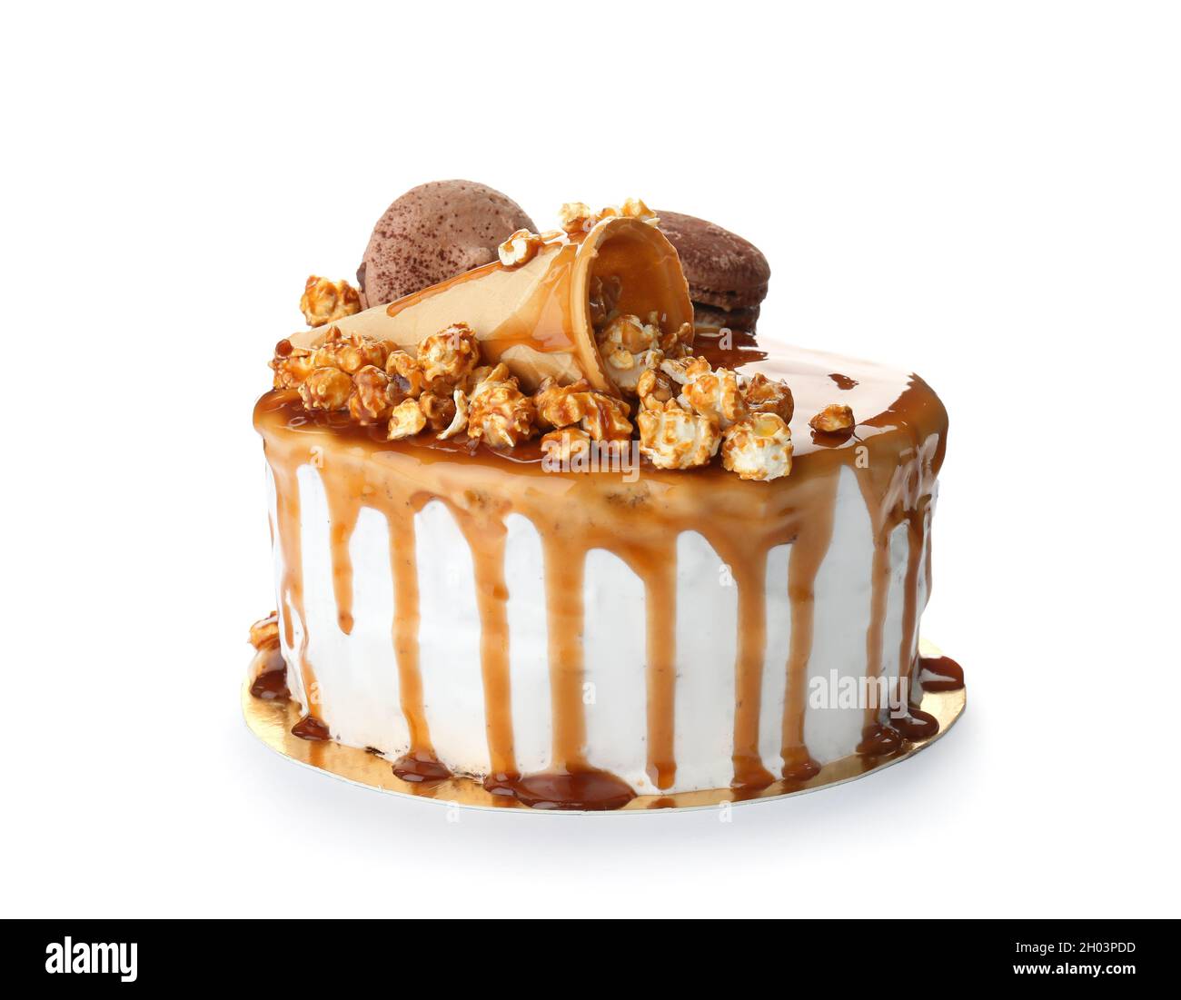 Delicious homemade cake with caramel sauce and popcorn on white ...