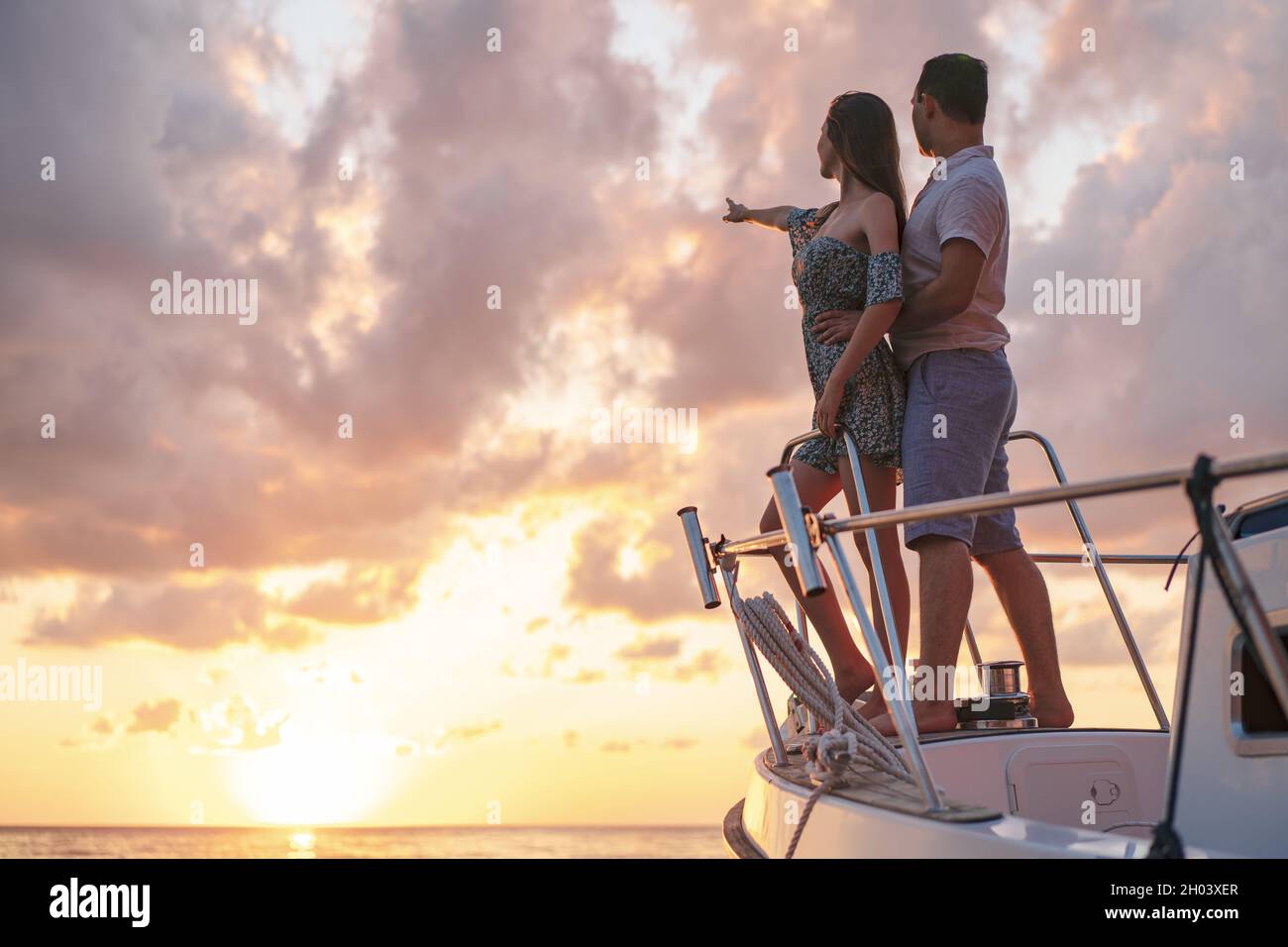 Beautiful couple looking at sunset from the yacht Stock Photo