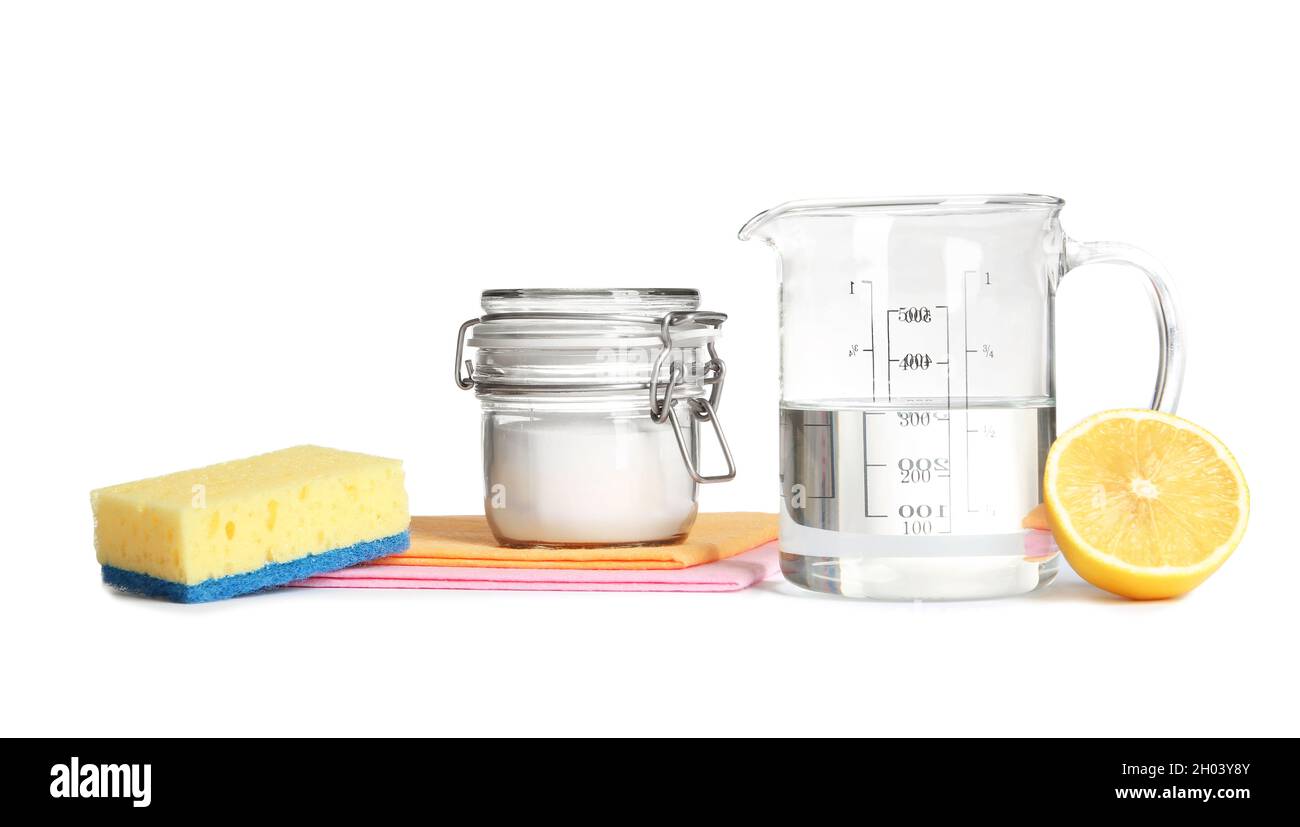Composition with vinegar, lemon and baking soda on white background