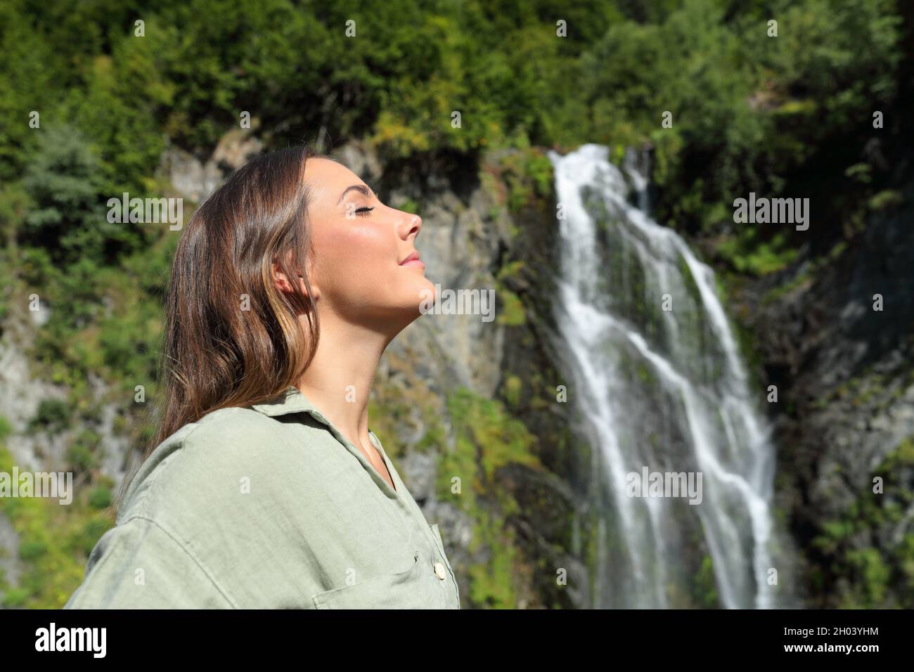 Profile portrait of a happy woman relaxing breathing fresh air in a ...