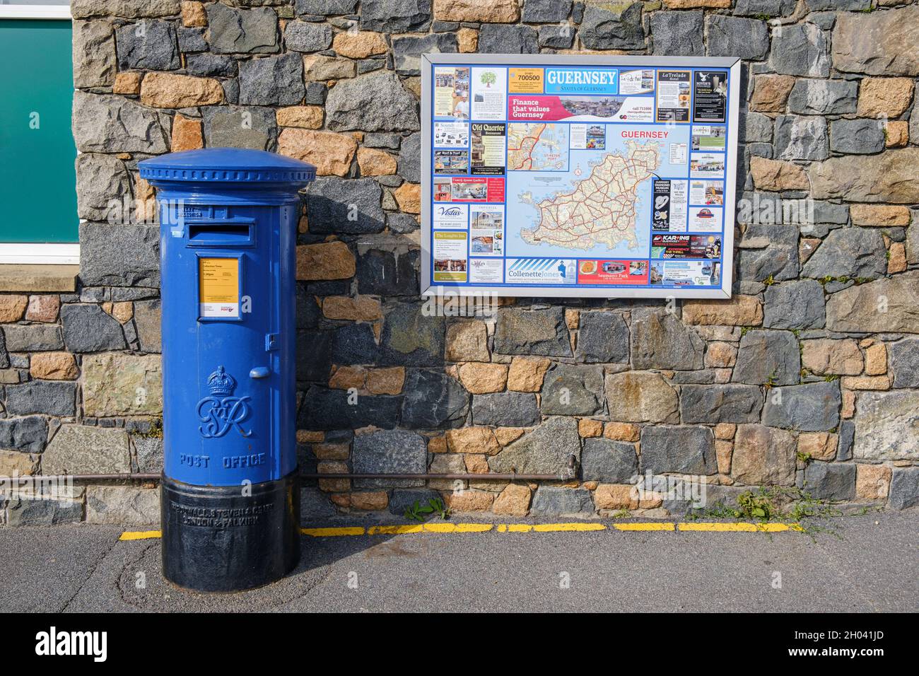 Blue post box and tourist map of Guernsey at the Morrisons Daily store and garage, Perelle, Guernsey, Channel Islands Stock Photo