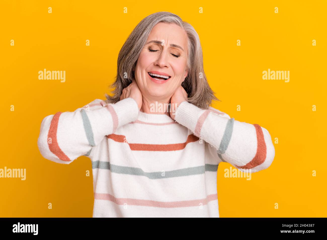 Photo of tired upset retired woman dressed white sweater arms neck having pain isolated yellow