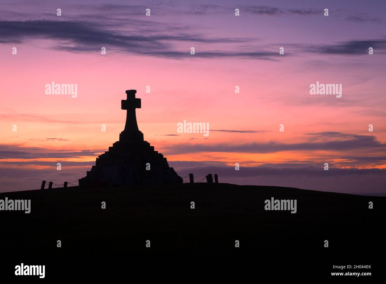 The imposing Newquay War memorial siulhouetted against a dramatic sunset in Cornwall. Stock Photo