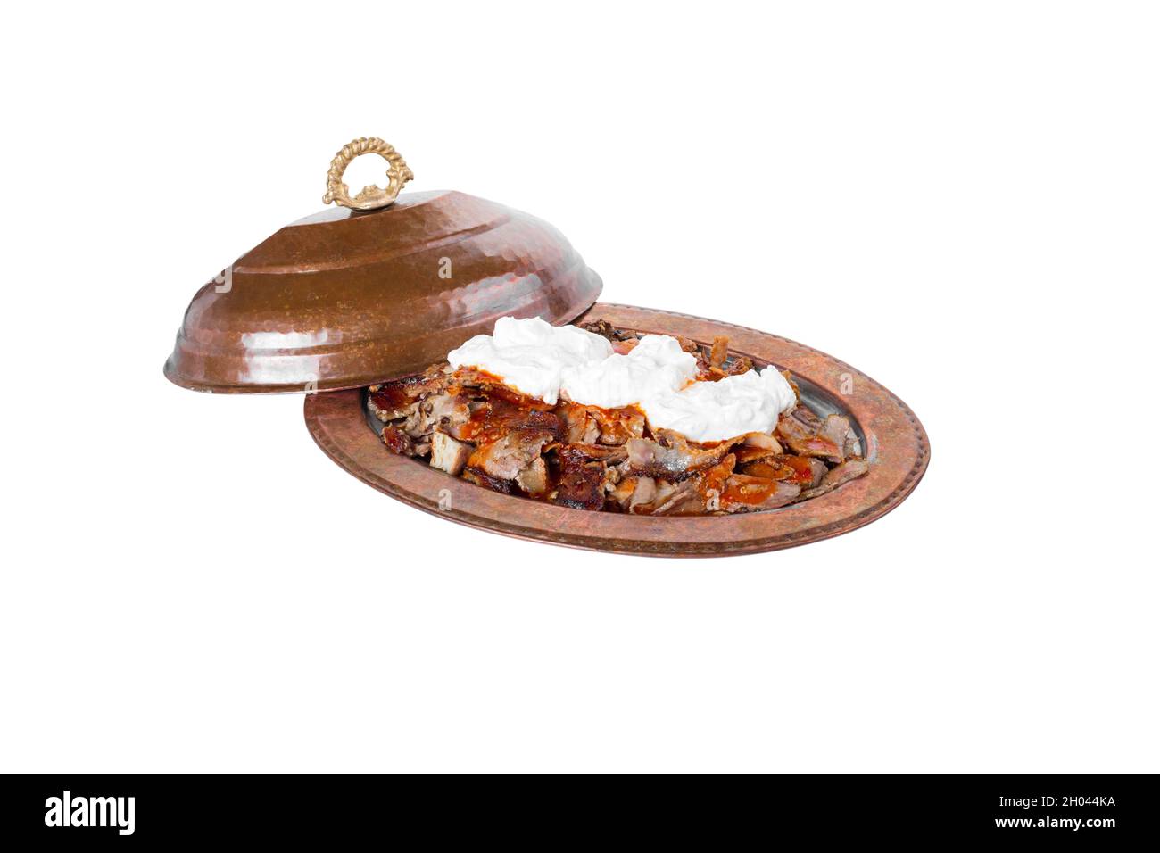 Traditional turkish iskender kebab in copper plate with yogurt and