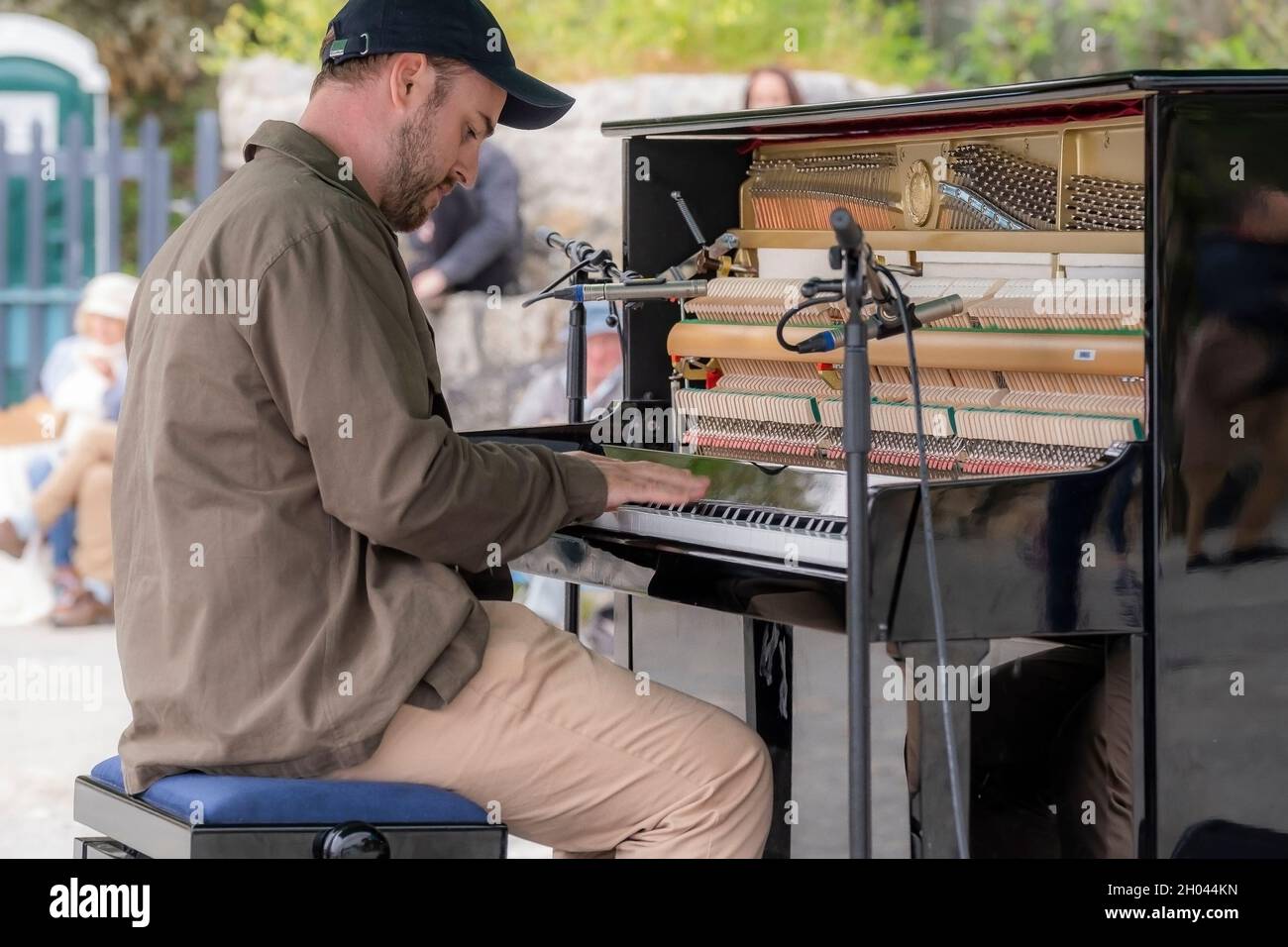 Contemporary pianist and composer Elliott Jacqués playing the piano on Trebah Garden beach in Polgwidden Cove in Cornwall. Stock Photo