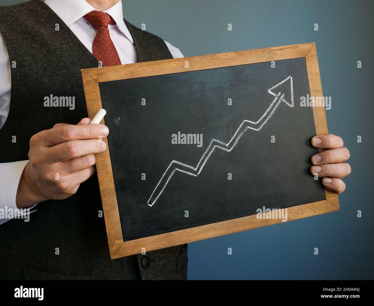 Business success. The manager holds a sign with an upward arrow drawn. Stock Photo