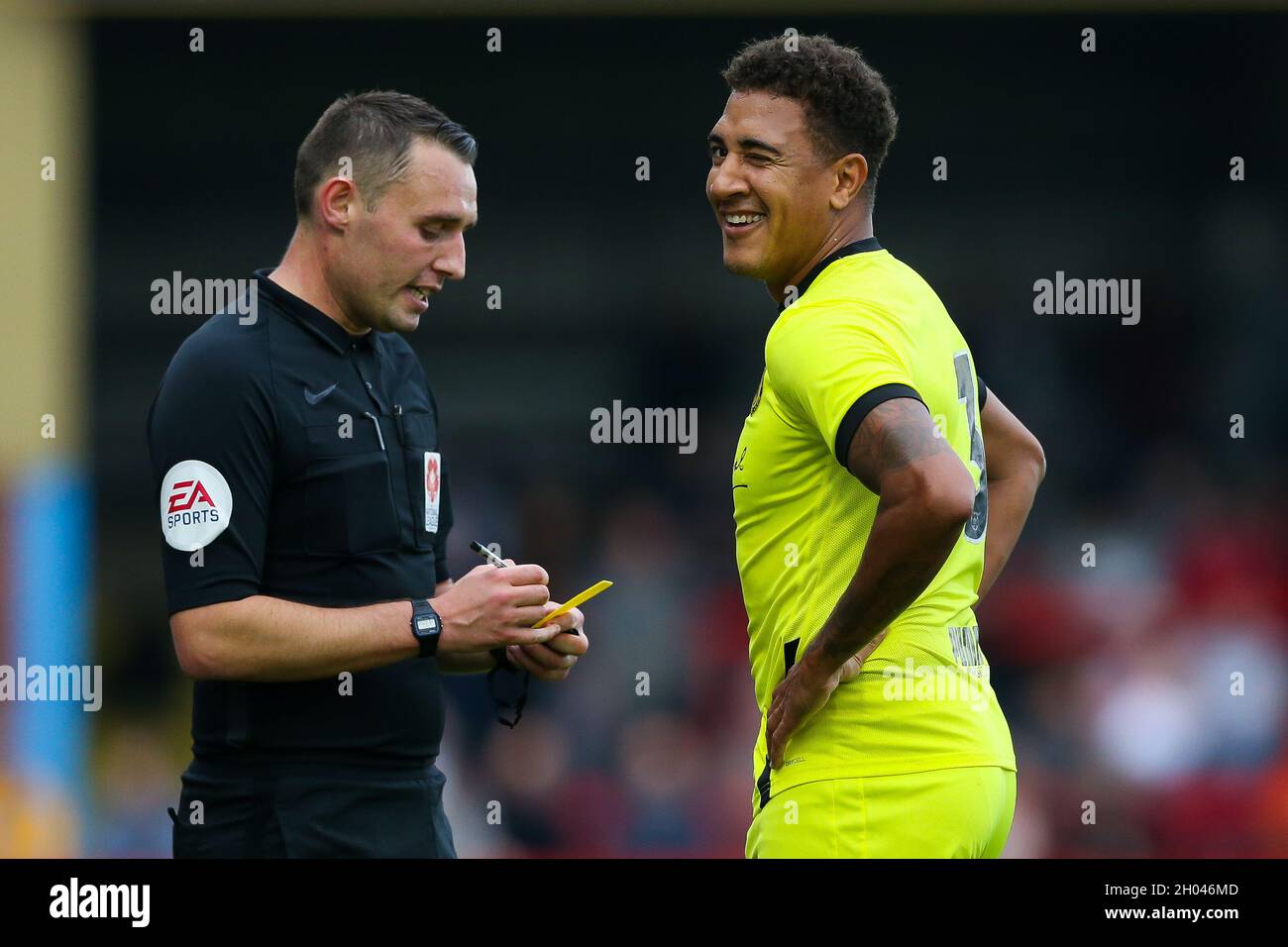 Referee Dale Wooton books Brackley Town's Glenn Walker during the National League North match at Aggborough, Kidderminster. Picture date: Saturday October 9, 2021. Stock Photo