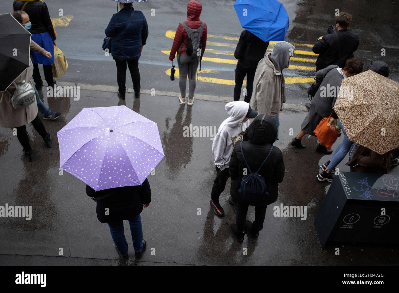 Belgrade, Serbia, Oct 7, 2021: Passengers waiting for a city bus on the rain Stock Photo