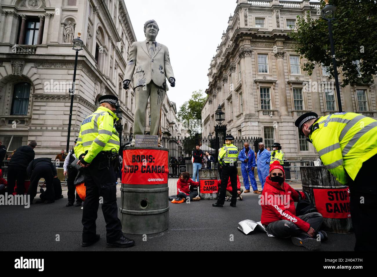 A statue of Prime Minister Boris Johnson splattered with oil as campaigners from Greenpeace demonstrate Downing Street, London, against the Cambo oil field off the west coast of Shetland. Picture date: Monday October 11, 2021. Stock Photo