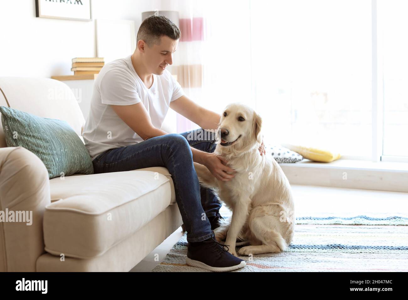 Portrait of owner with his friendly dog at home Stock Photo - Alamy