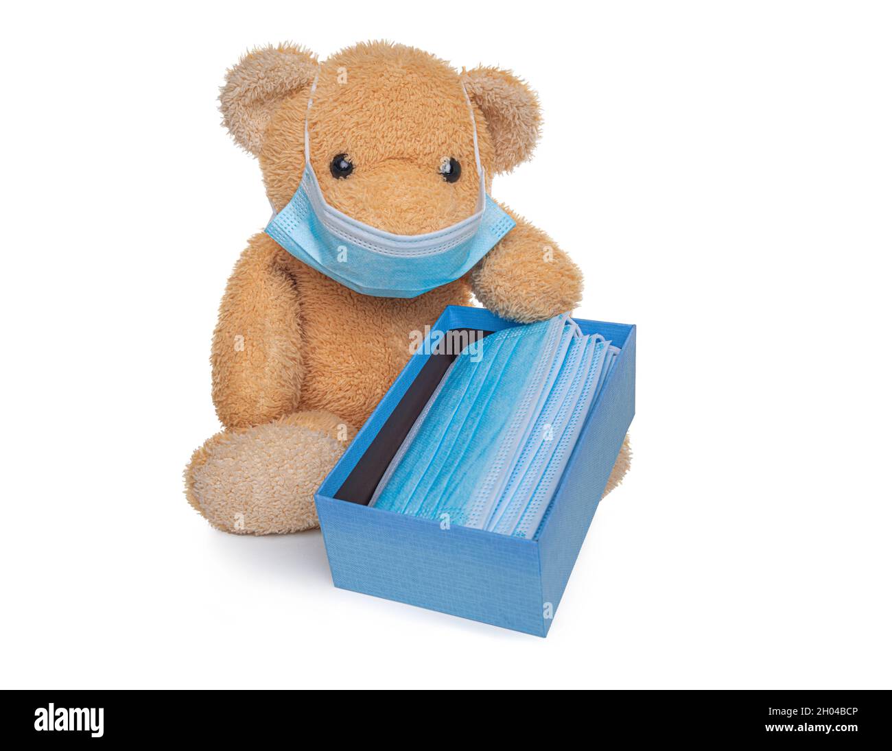 Teddy bear soft toy holds a box with medical masks Stock Photo - Alamy