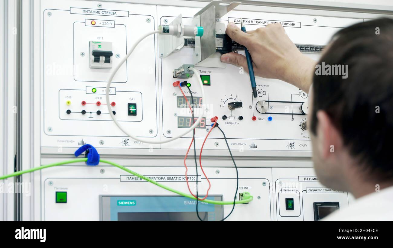 Worker checks control panel in modern factory. Scene. Work controller ...