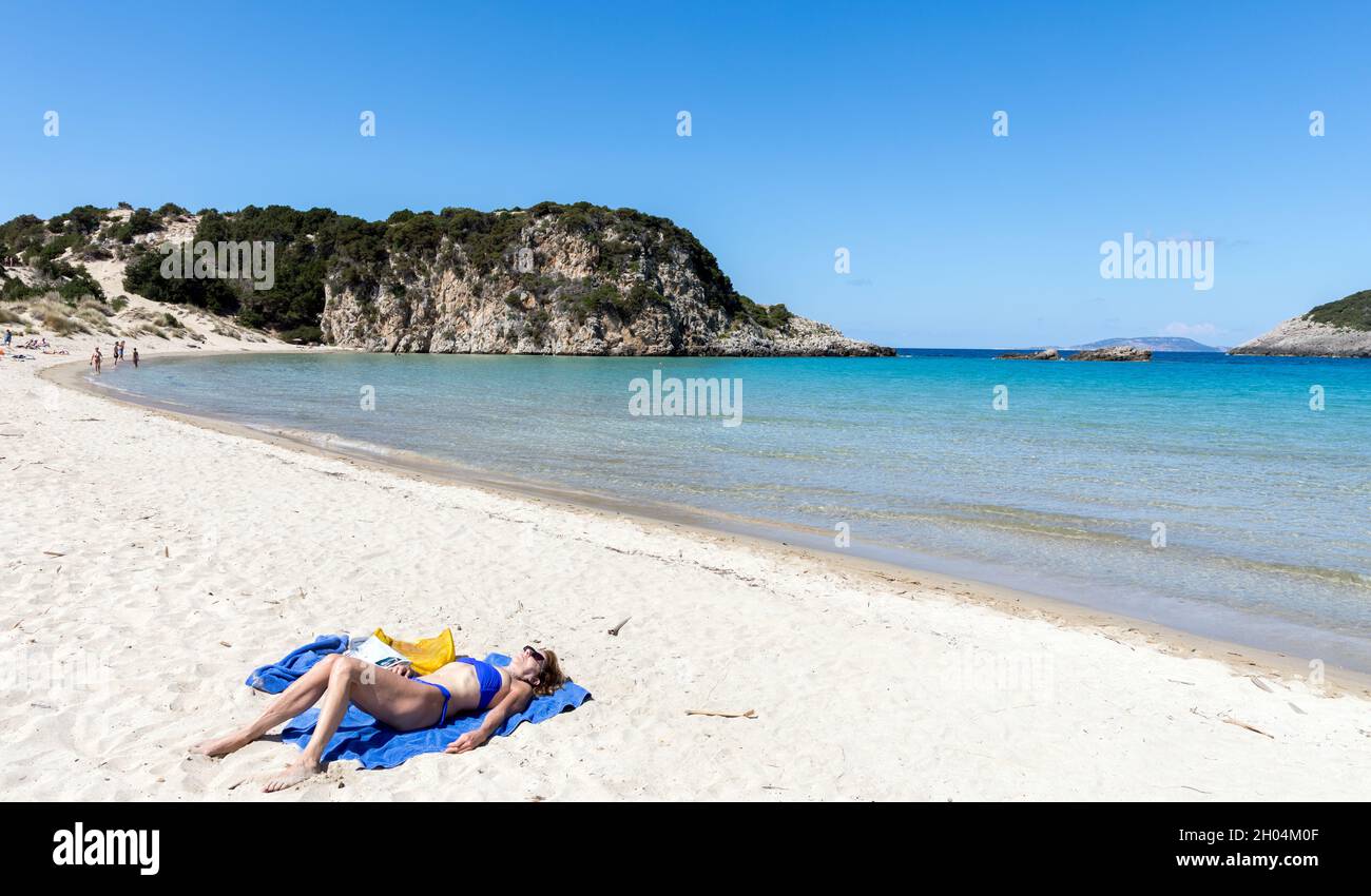 Woman Sunbathing On Voidokilias Beach Pylos Peloponnese Greece Stock Photo