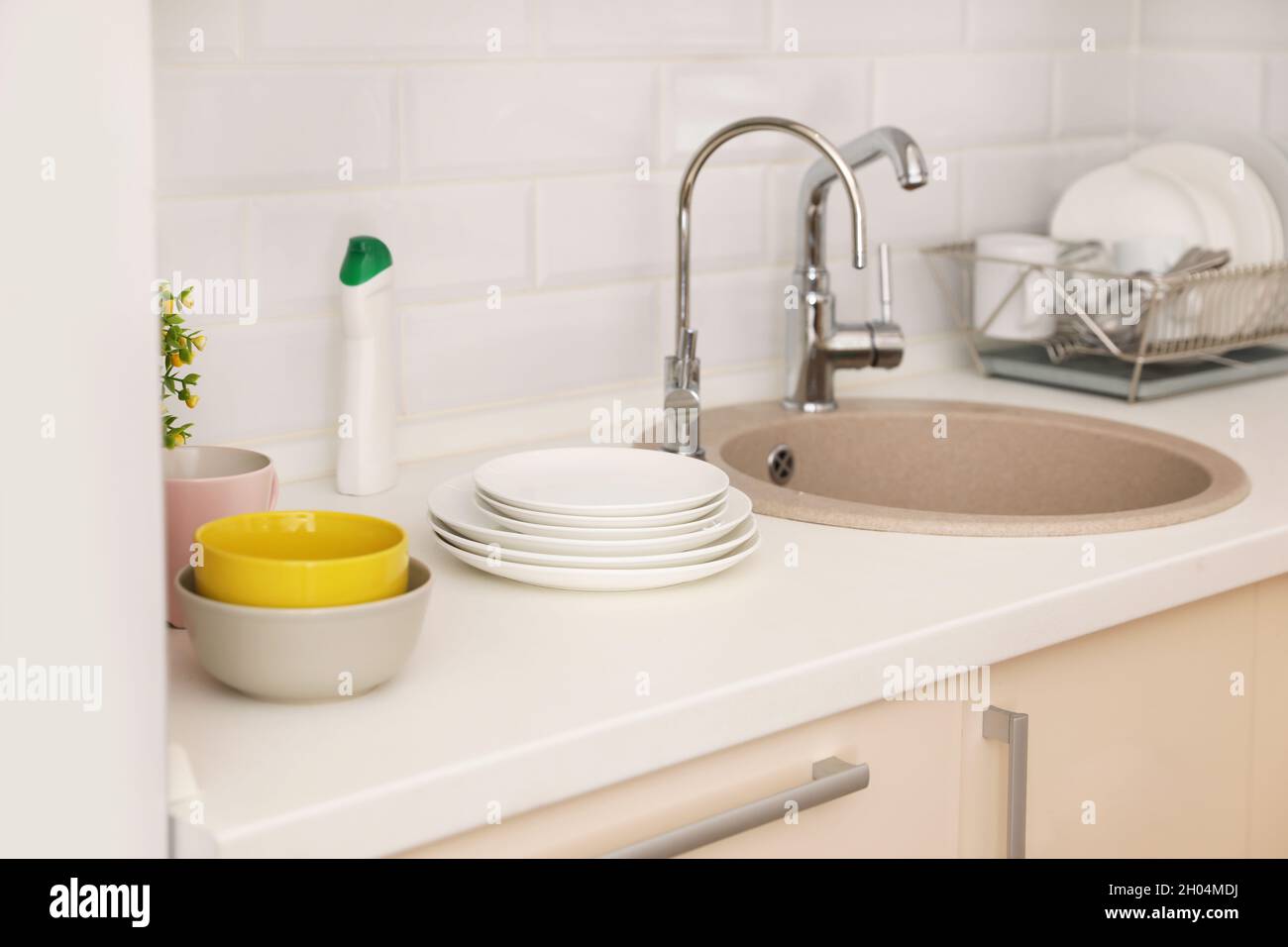 Clean dishes on counter near kitchen sink indoors Stock Photo Alamy