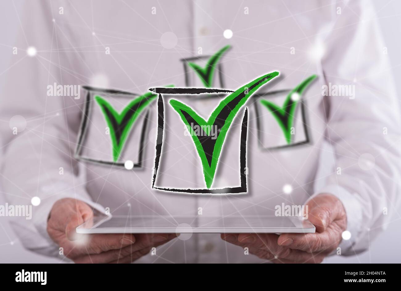 Validation concept above a tablet held by a man in background Stock Photo