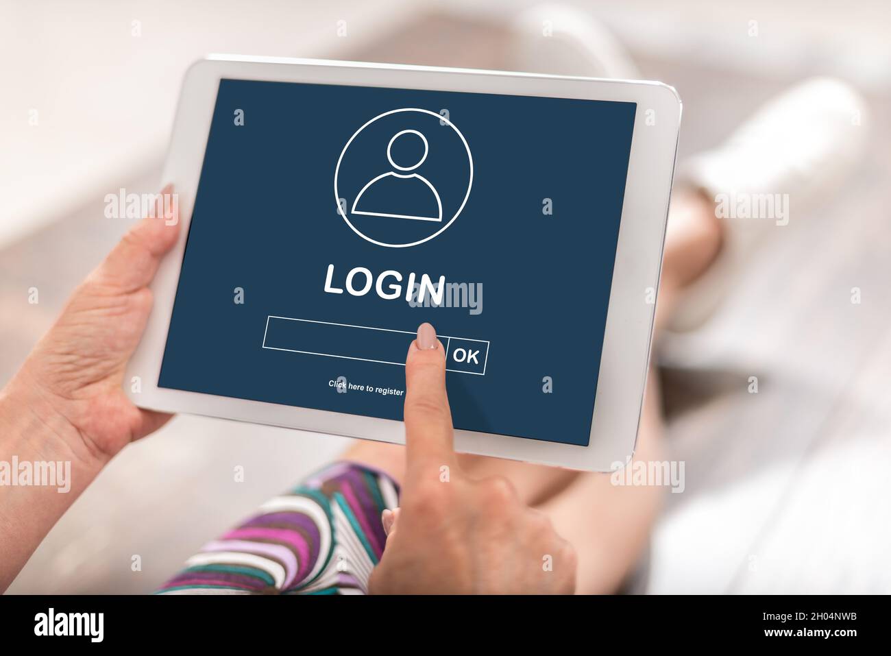 Woman using a tablet with login concept Stock Photo