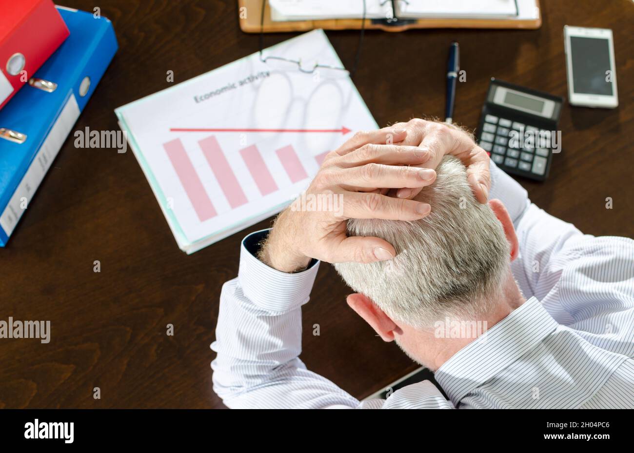 Despairing businessman because of the economic crisis Stock Photo