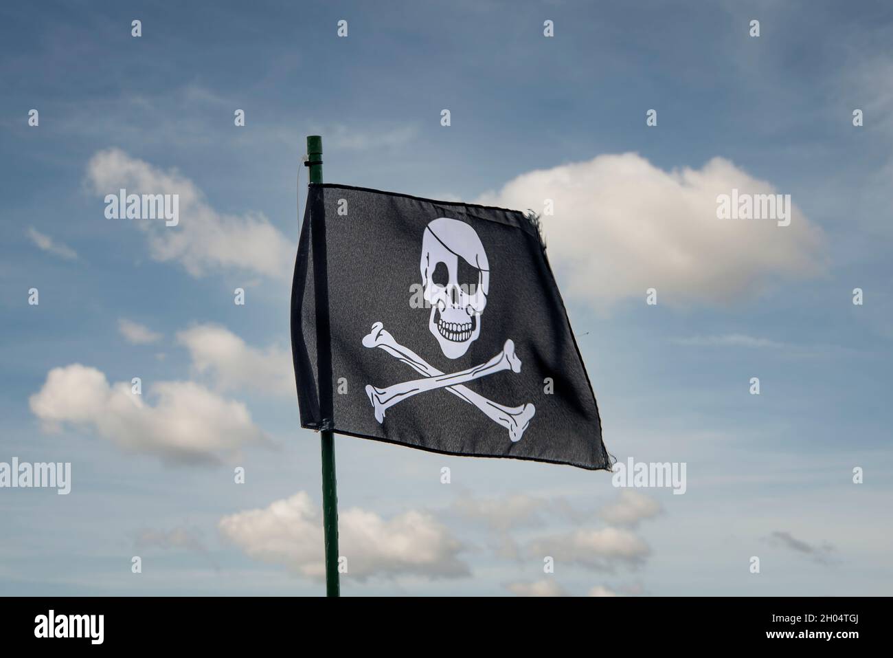 Skull and crossbones, pirate flag against a blue sky Stock Photo Alamy