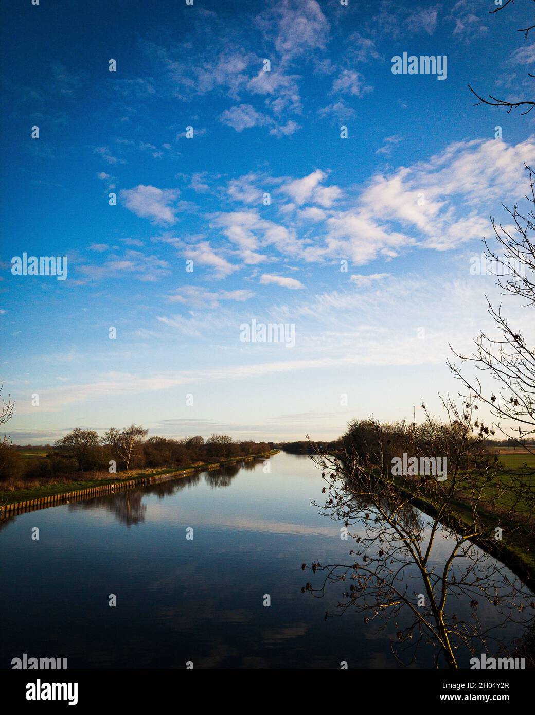 Vertical vanishing point shot of a river with natural landscape ...