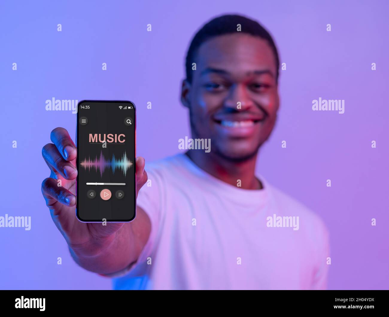 Cheerful Black Guy Holding Smartphone With Music Media Player Interface ...