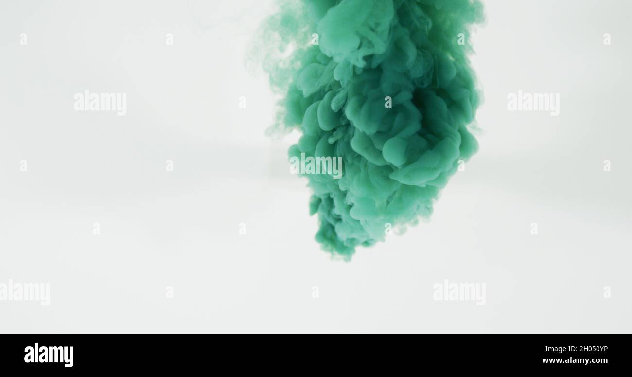 Green cloud of smoke moving on white background Stock Photo - Alamy