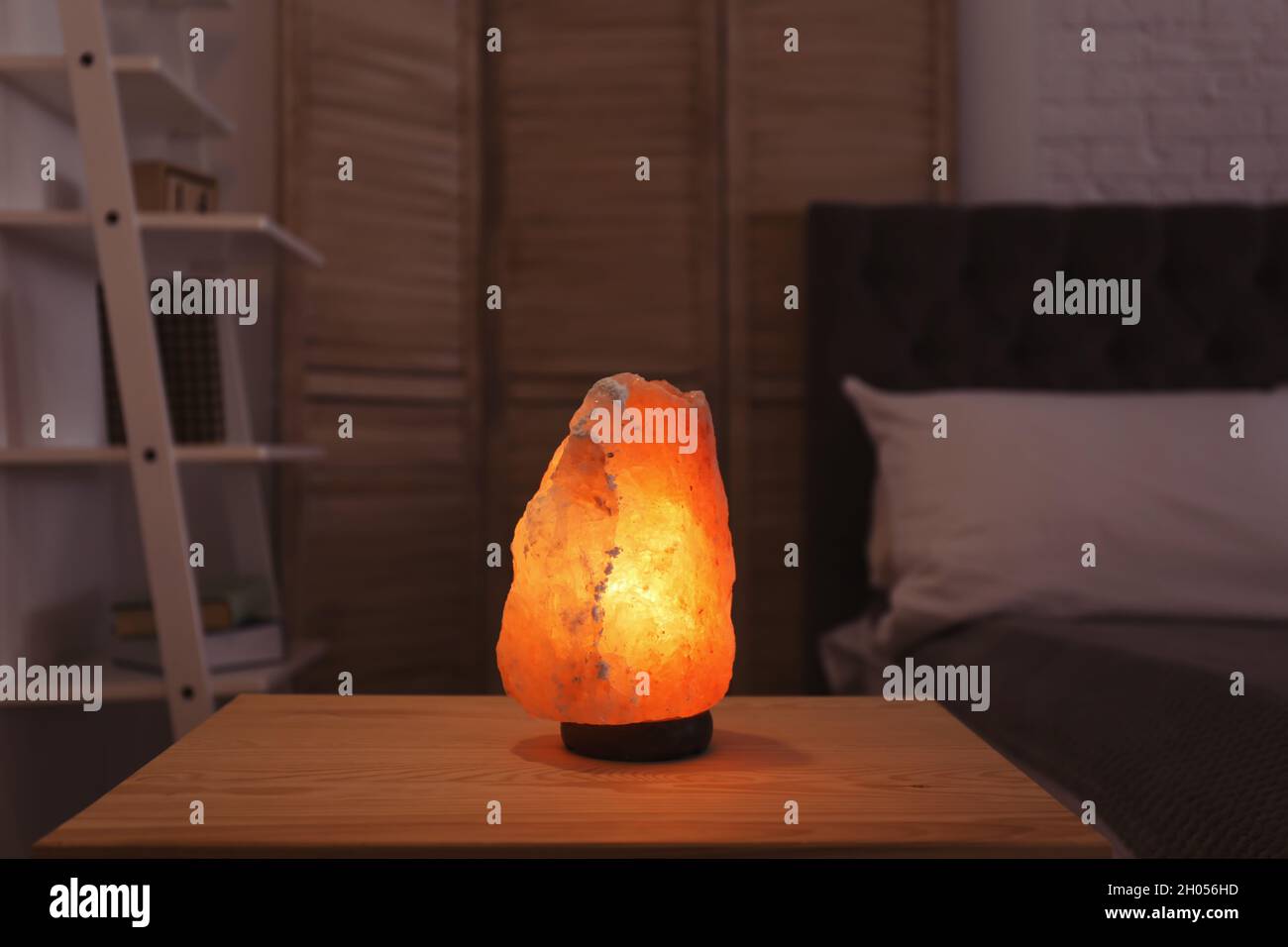 Himalayan salt lamp on table in dark room Stock Photo Alamy