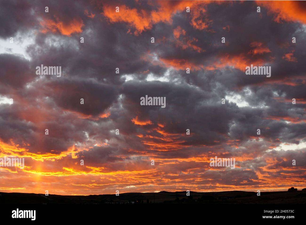 Dramatic sky with orange and purple clouds just after sunset Stock Photo
