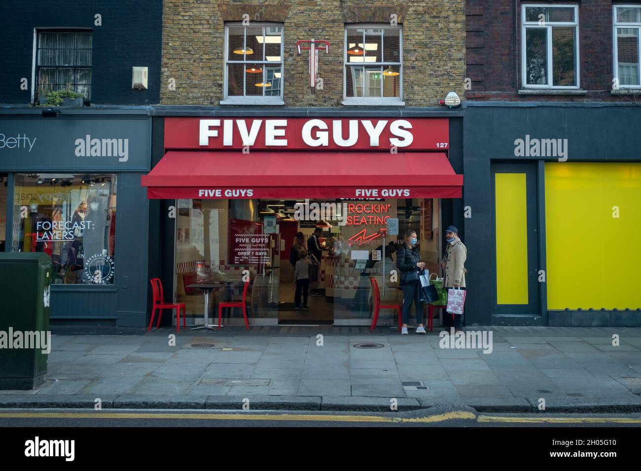 London- October 2021: Five Guys take away food restaurant on Kings Road Chelsea Stock Photo