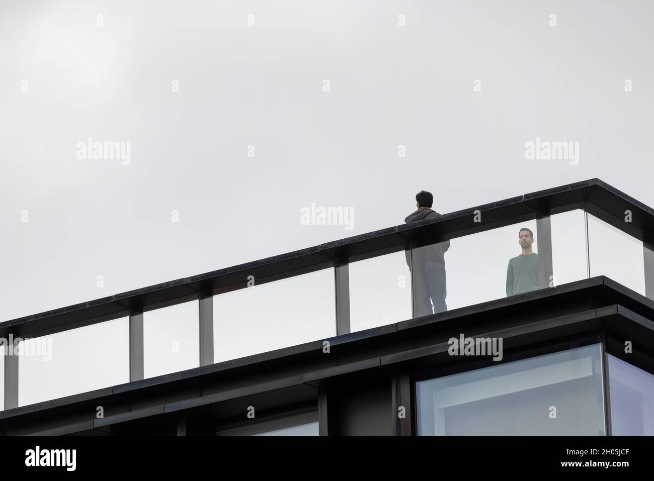 men standing on modern office rooftop in London UK Stock Photo