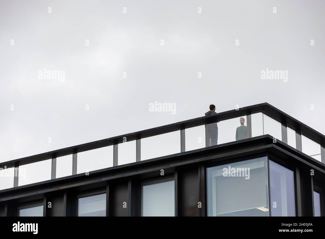 men standing on modern office rooftop in London UK Stock Photo