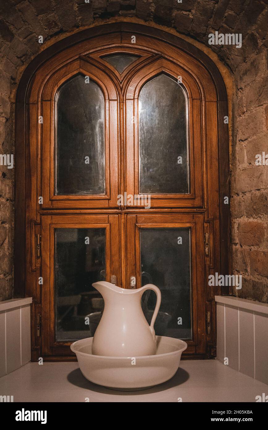 Bowl with pitcher outside the door of a brick house Stock Photo Alamy