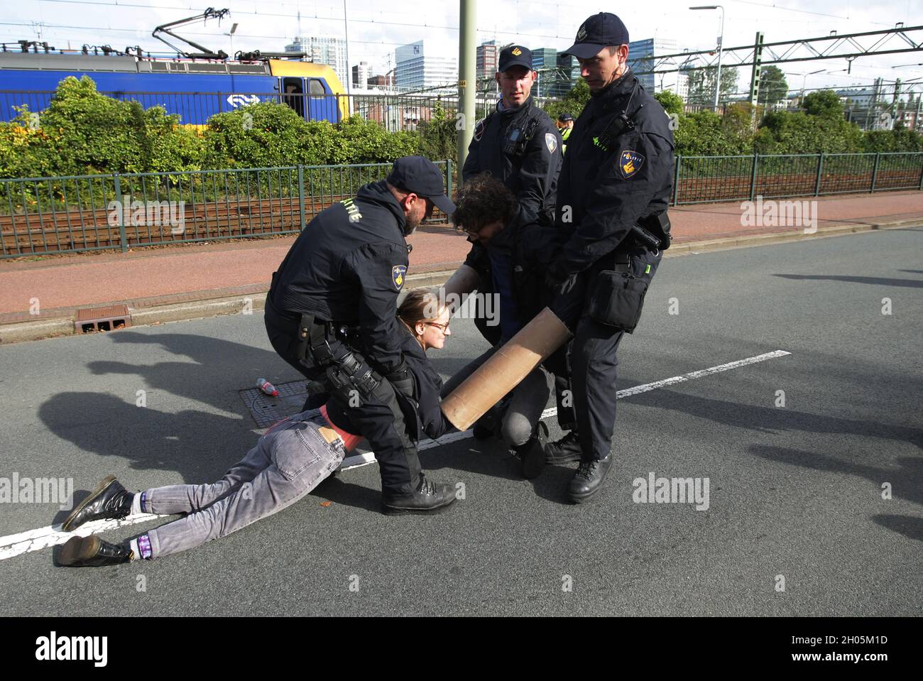 Dutch anti-riot police officers arrest two Extinction Rebellion ...