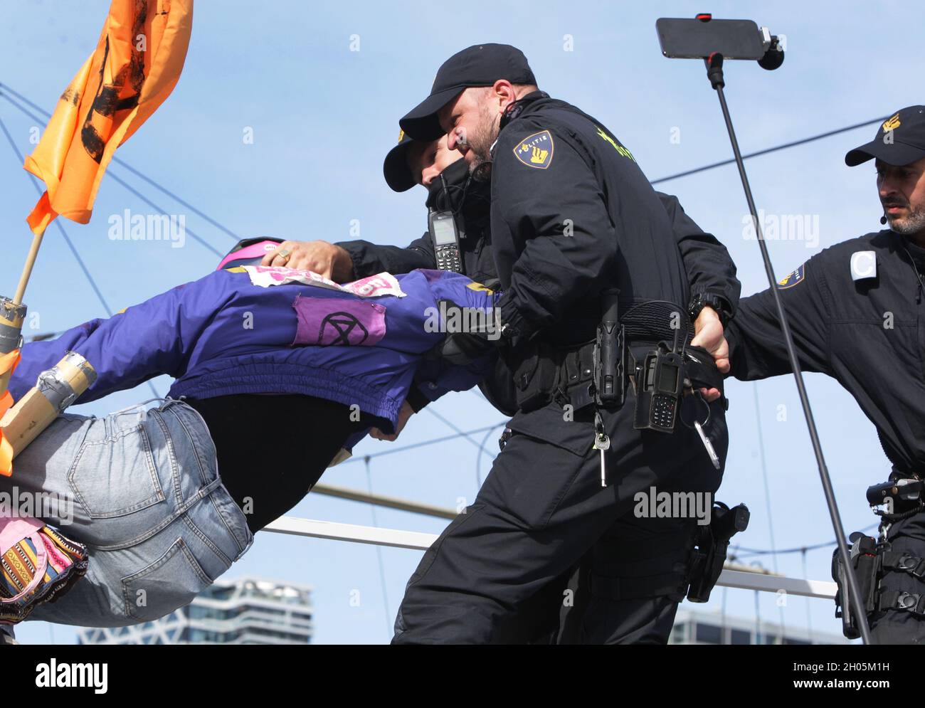 Dutch anti-riot police officers arrest an Extinction Rebellion ...