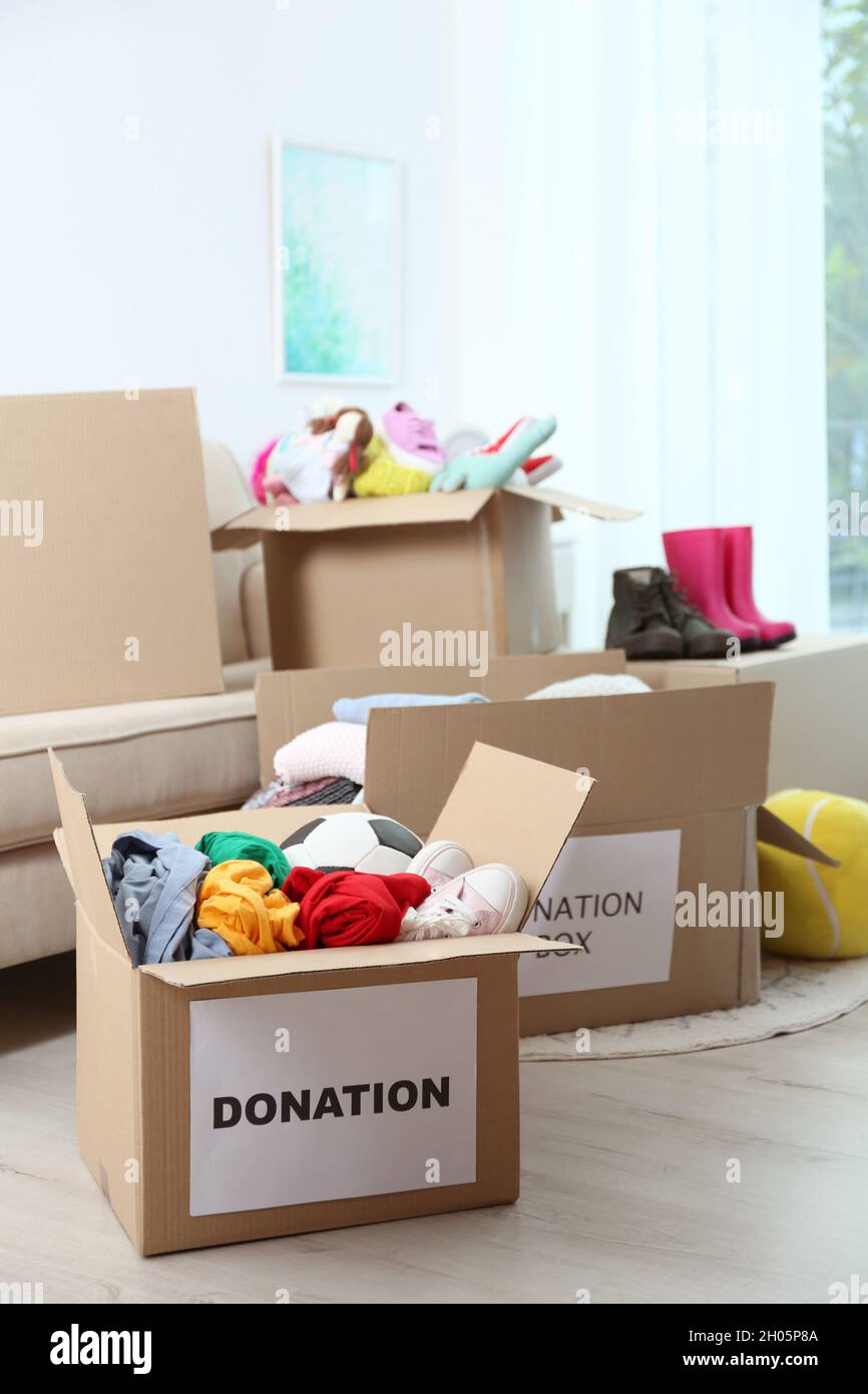 Carton boxes with donations in living room Stock Photo Alamy