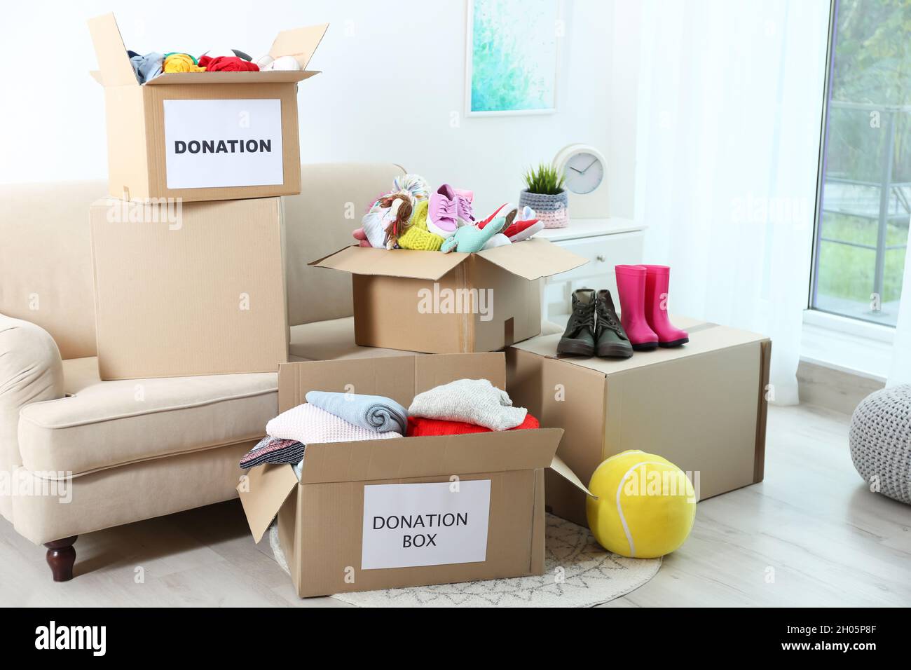 Carton boxes with donations in living room Stock Photo Alamy