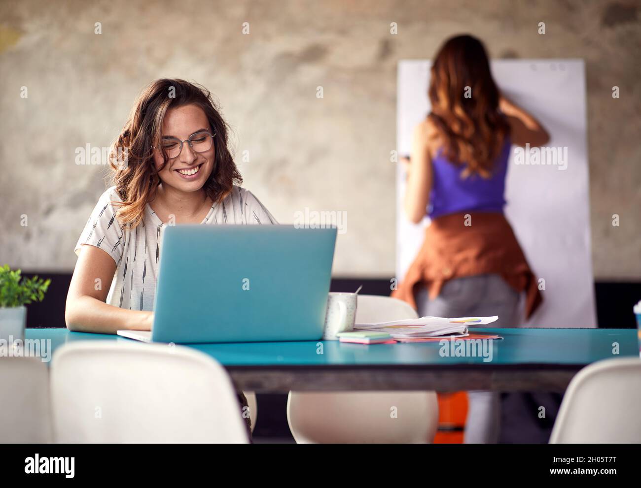 Young woman is in a good mood while working in a pleasant atmosphere in the office Stock Photo