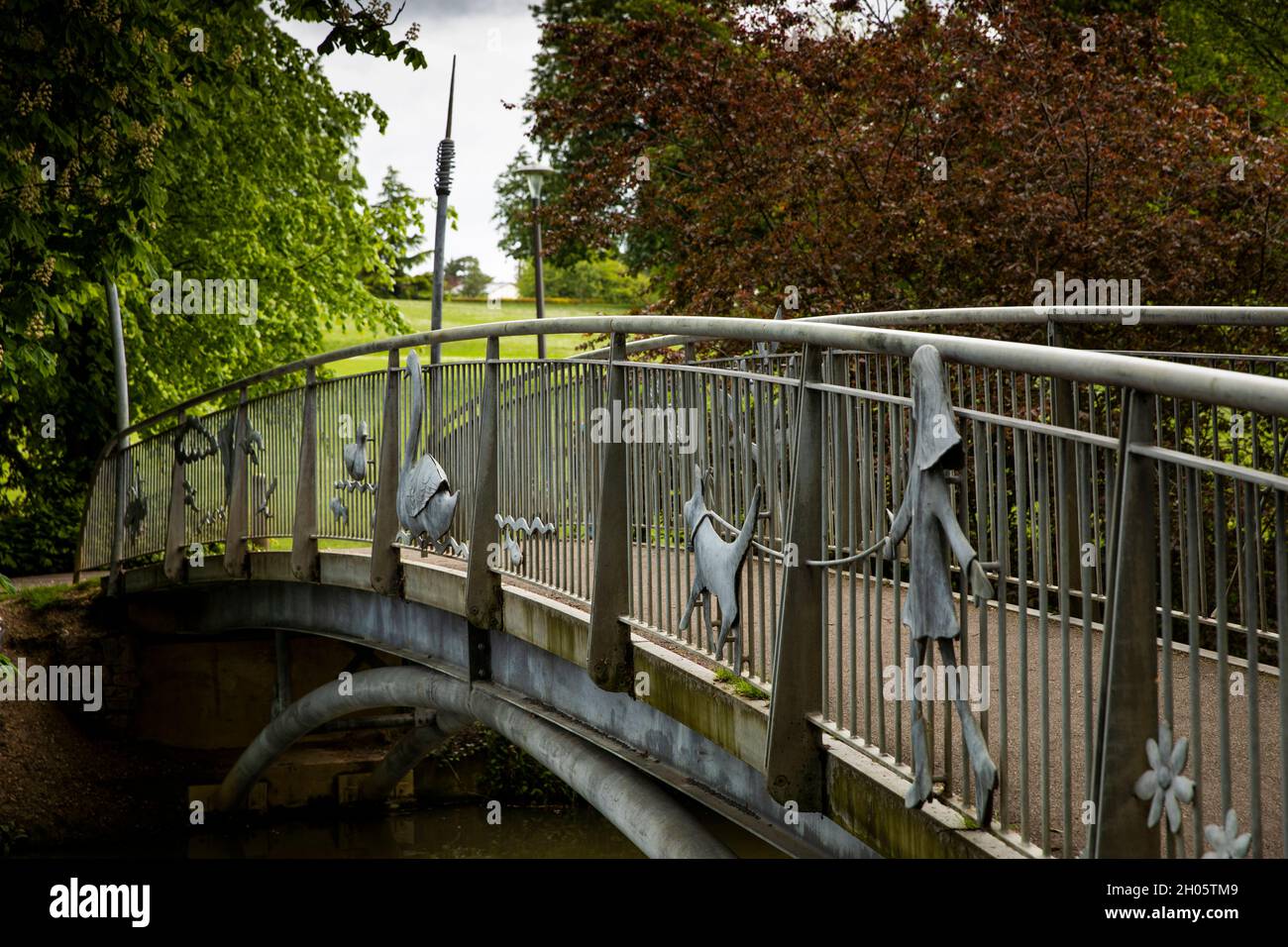 UK, Gloucestershire, Cheltenham, Pittville Park, Community bridge across boating lake by Christopher Lisney Stock Photo