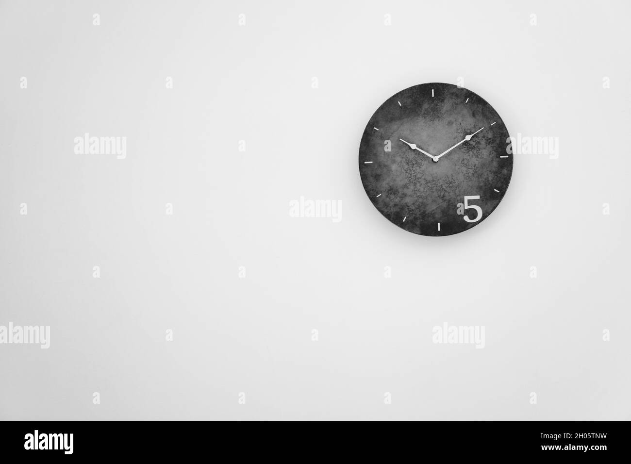 Analog clock hanging on wall. Time of day Stock Photo Alamy