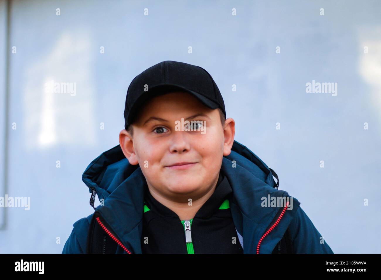 Portrait of preteen surprised happy boy close-up in jacket and cap standing  outdoor. Funny teen child with bulge eyes. Handsome school kid outside  Stock Photo - Alamy