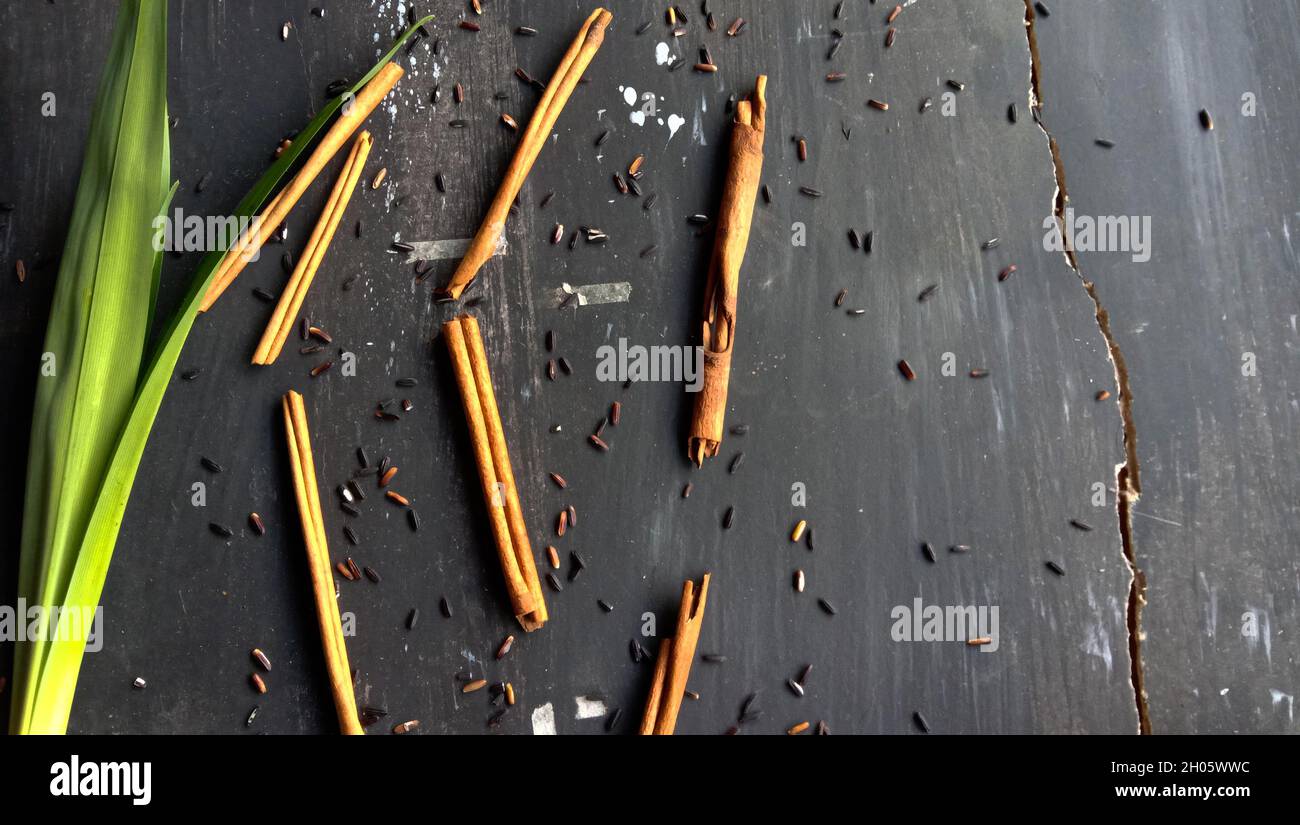 Black sticky rice, and cinnamon on a rustic background Stock Photo - Alamy