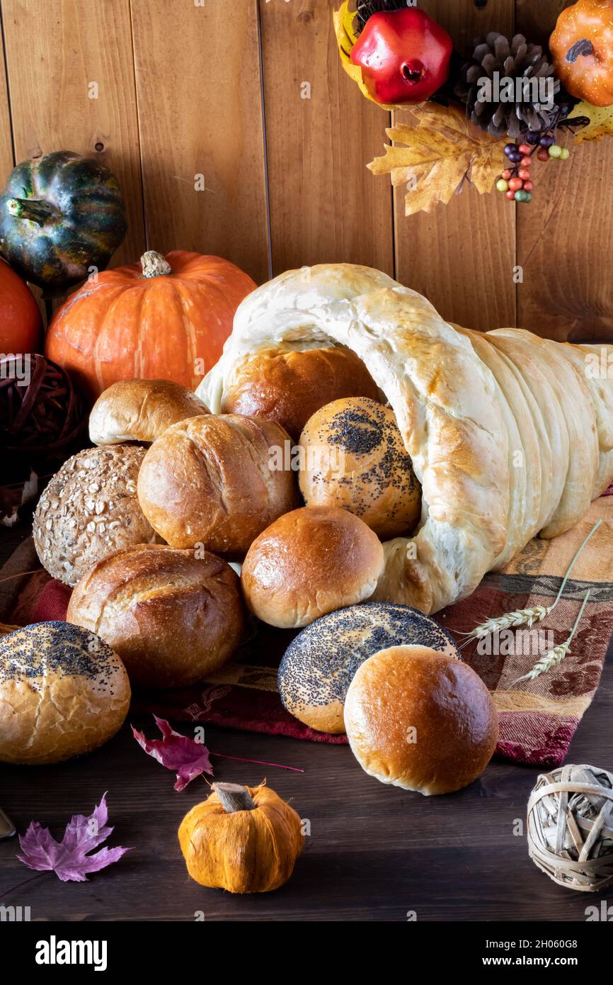 Close up of a bread cornucopia overflowing with rolls. Stock Photo