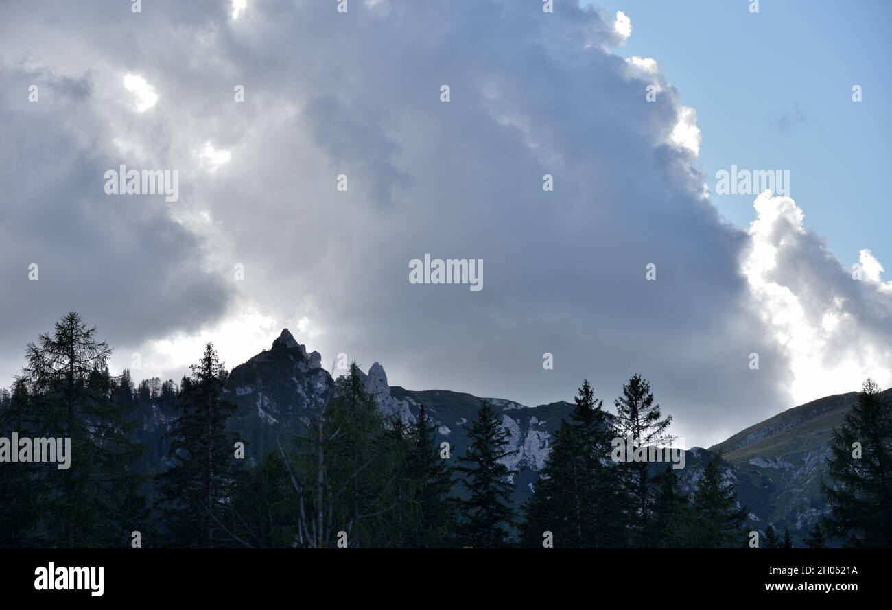 In the Braies valley clouds over the Spitzkofel, strange disordered rocks that a local legend calls 'the drunkards of Braies' Stock Photo