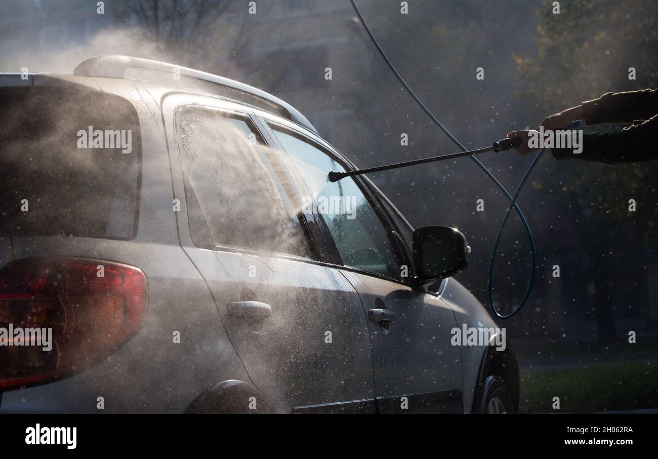 Manual washing car with high pressure water at sunrise Stock Photo Alamy