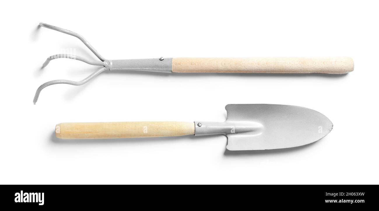 Trowel And Rake New rake and trowel on white background. Professional gardening tools ...